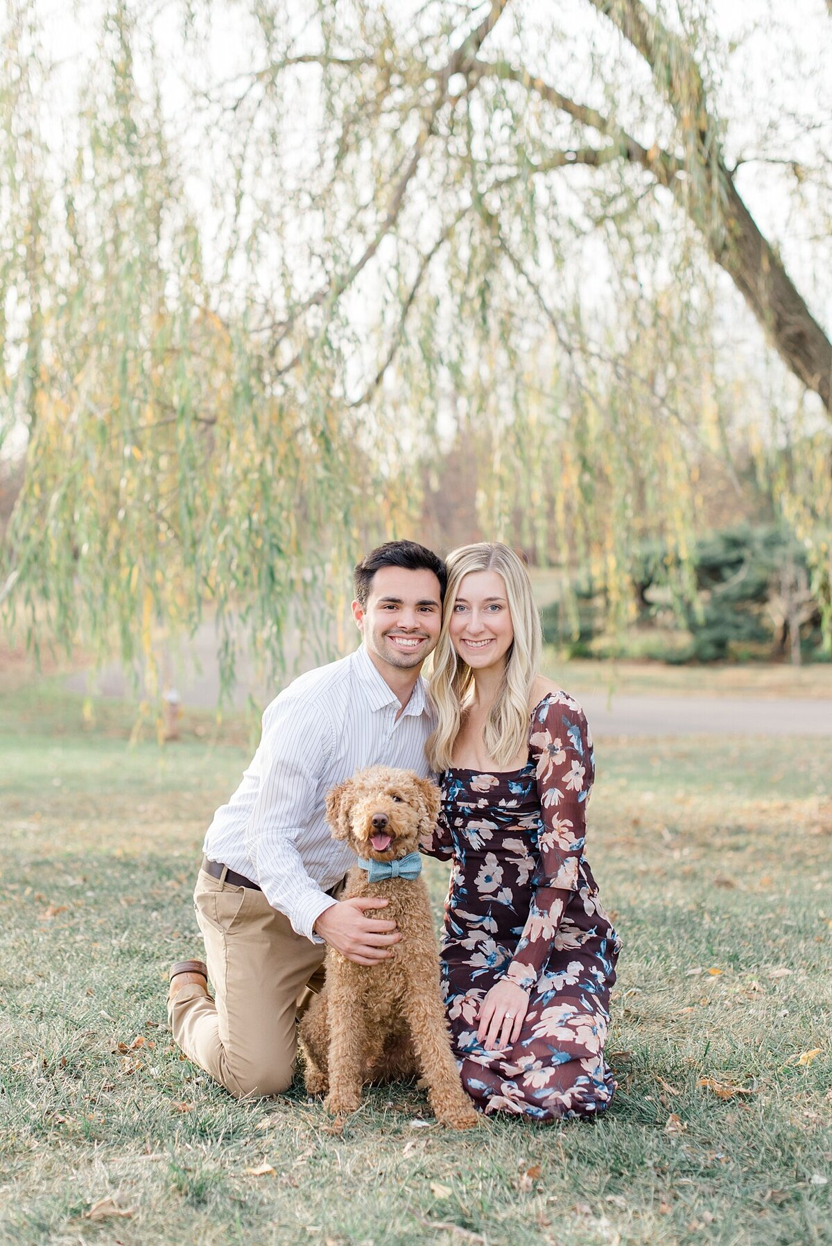 The best Columbus, Ohio wedding photographer poses couple with dog at Franklin Park