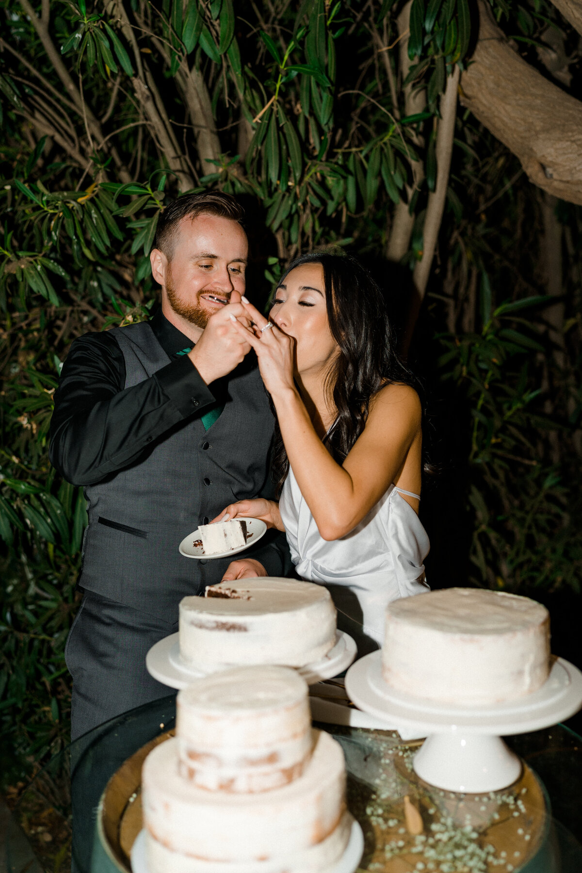 groom feeding bride a bite of cake