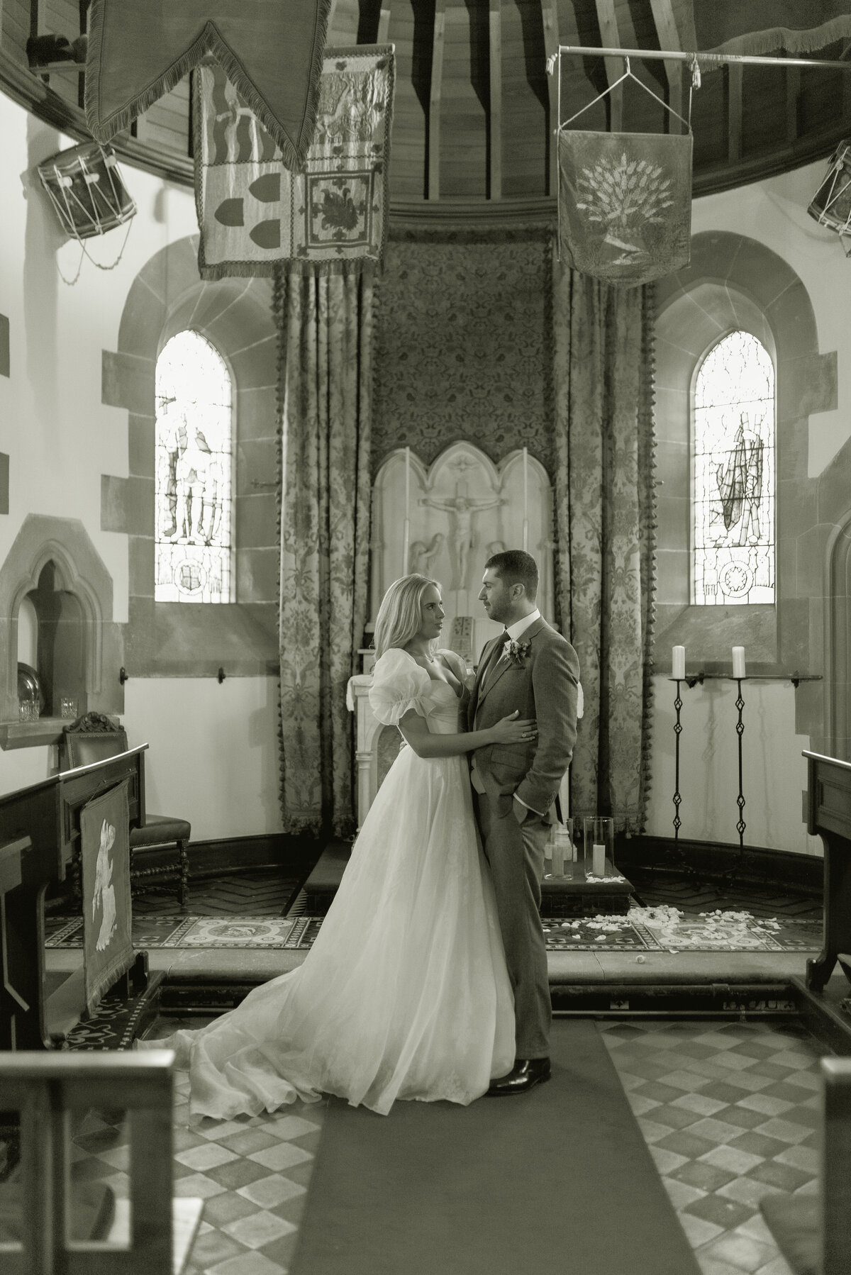 Black and white wedding photography of Bride and Groom in the Chapel at Cromlix House, Scotland, on their summer wedding day, photographed by fine art wedding photographer UK.