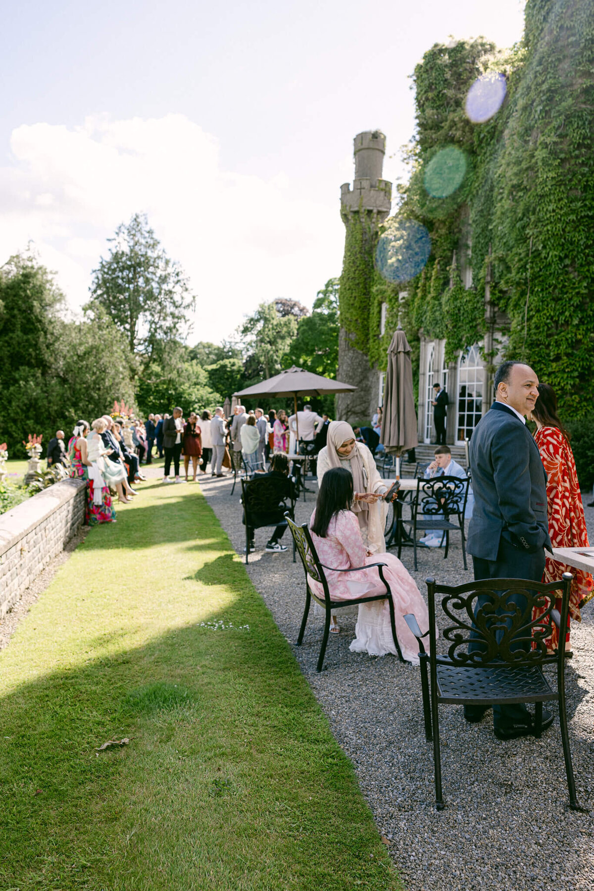 A wedding photo of guests during cocktail hour at Luttrellstown Castle in Ireland