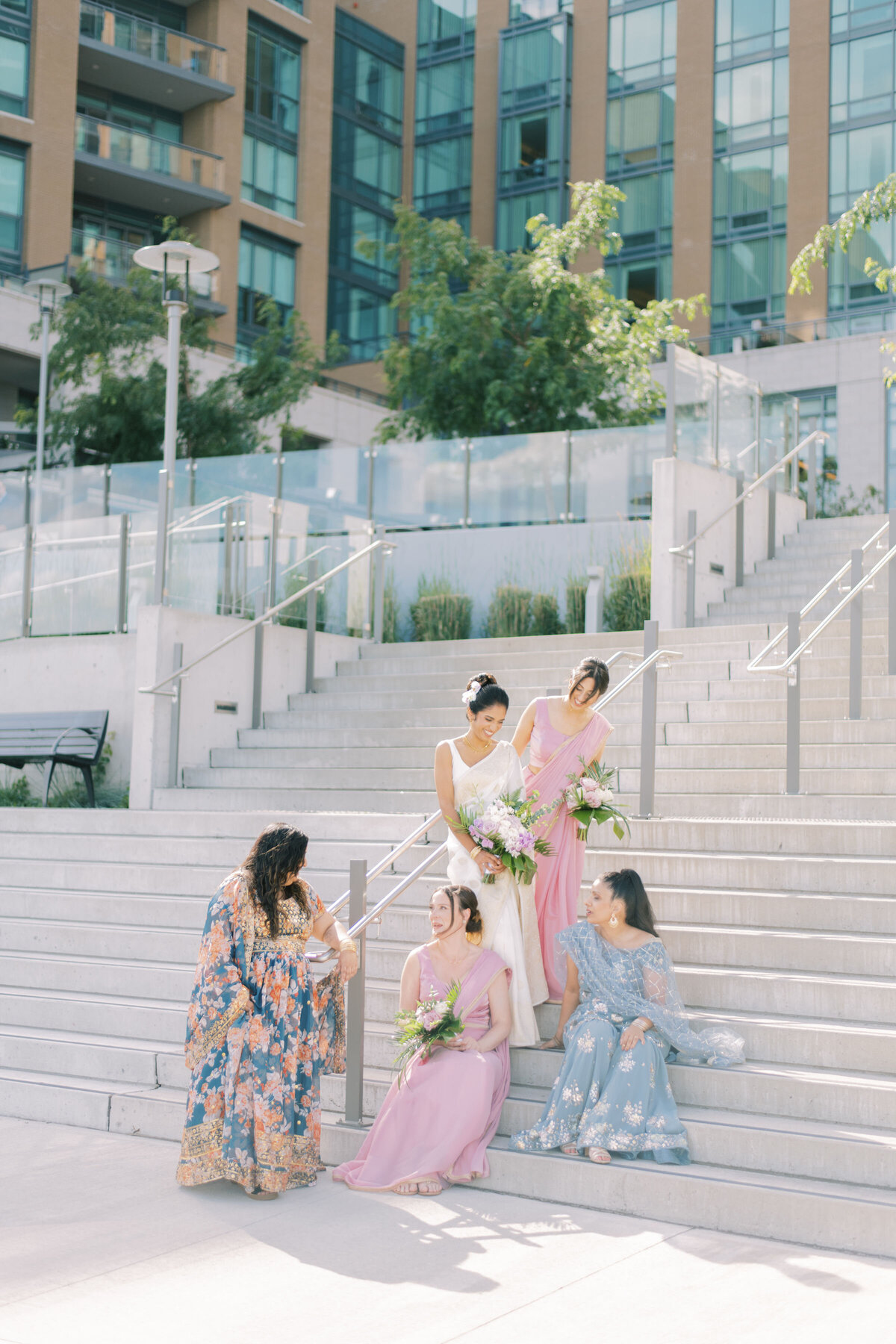 Bridal party sharing a joyful moment, laughing together at The Pearle Hotel in Burlington during an Indian wedding.
