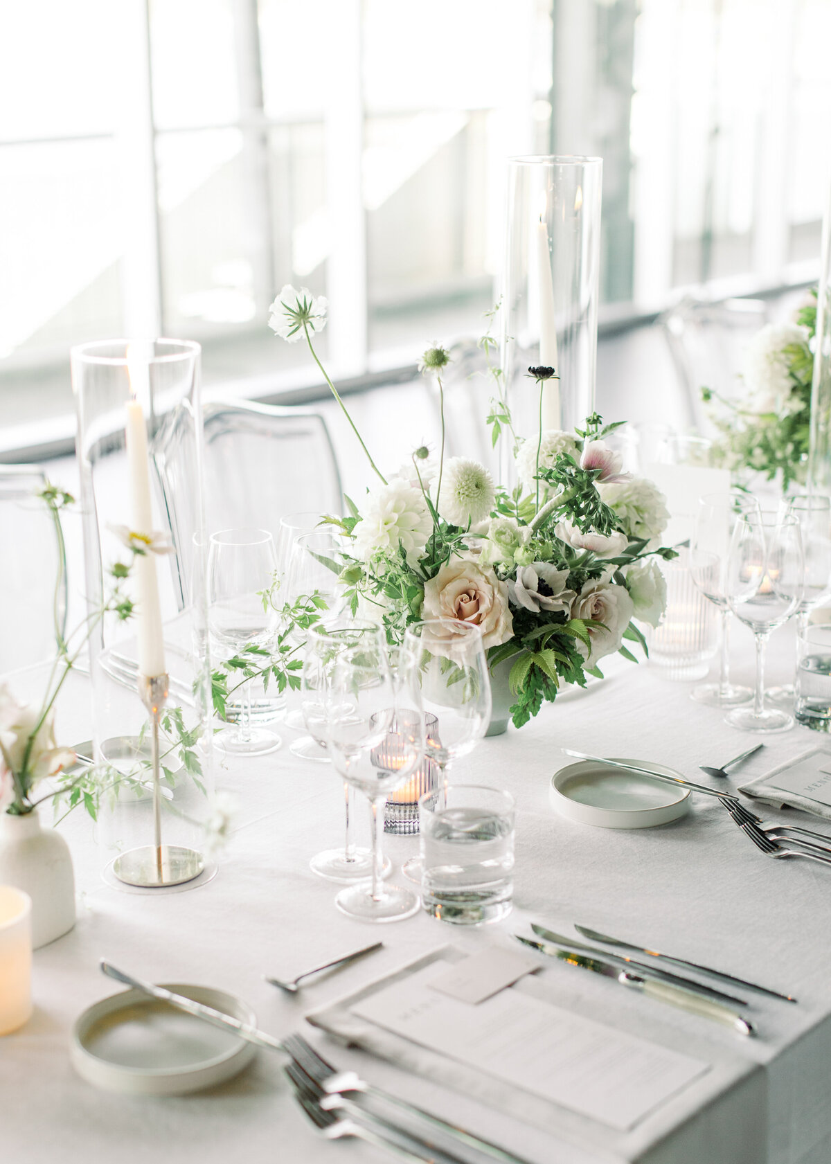 A beautiful floral garden centrepiece sits on a table at a Science Centre wedding reception.