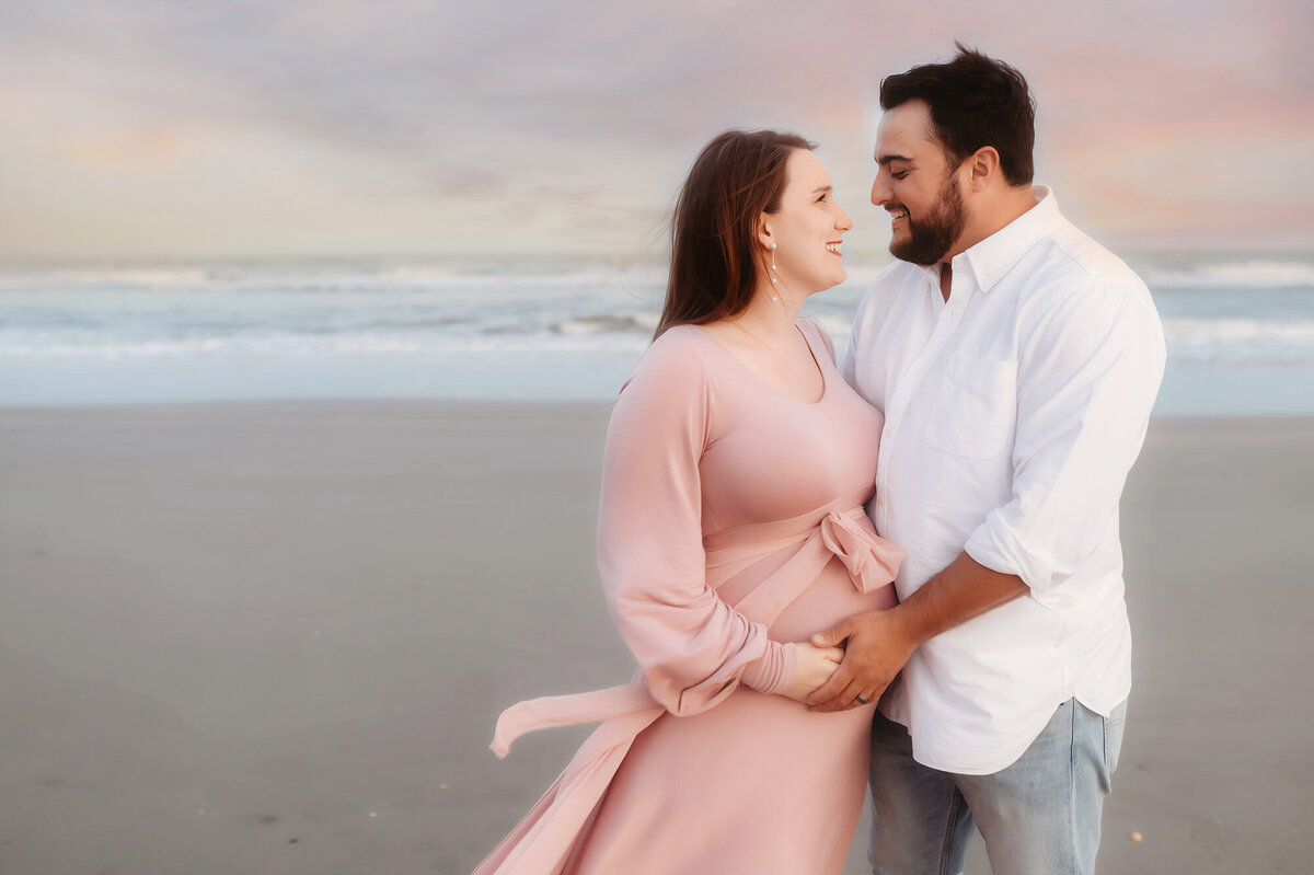 During their Babymoon in Charleston, expectant parents pose for Beach Maternity Photos in Charleston, SC.