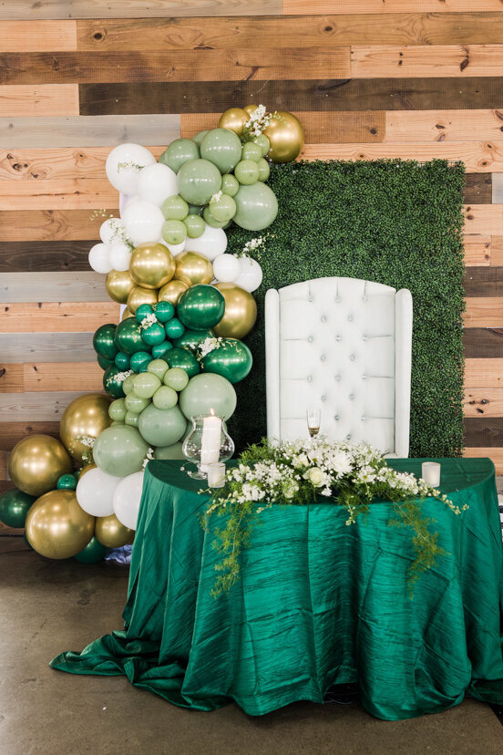 white-chair-green-gold-balloons