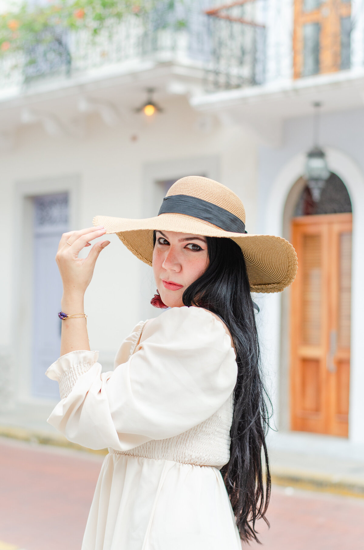 woman in casco viejo, panama, tips her hat