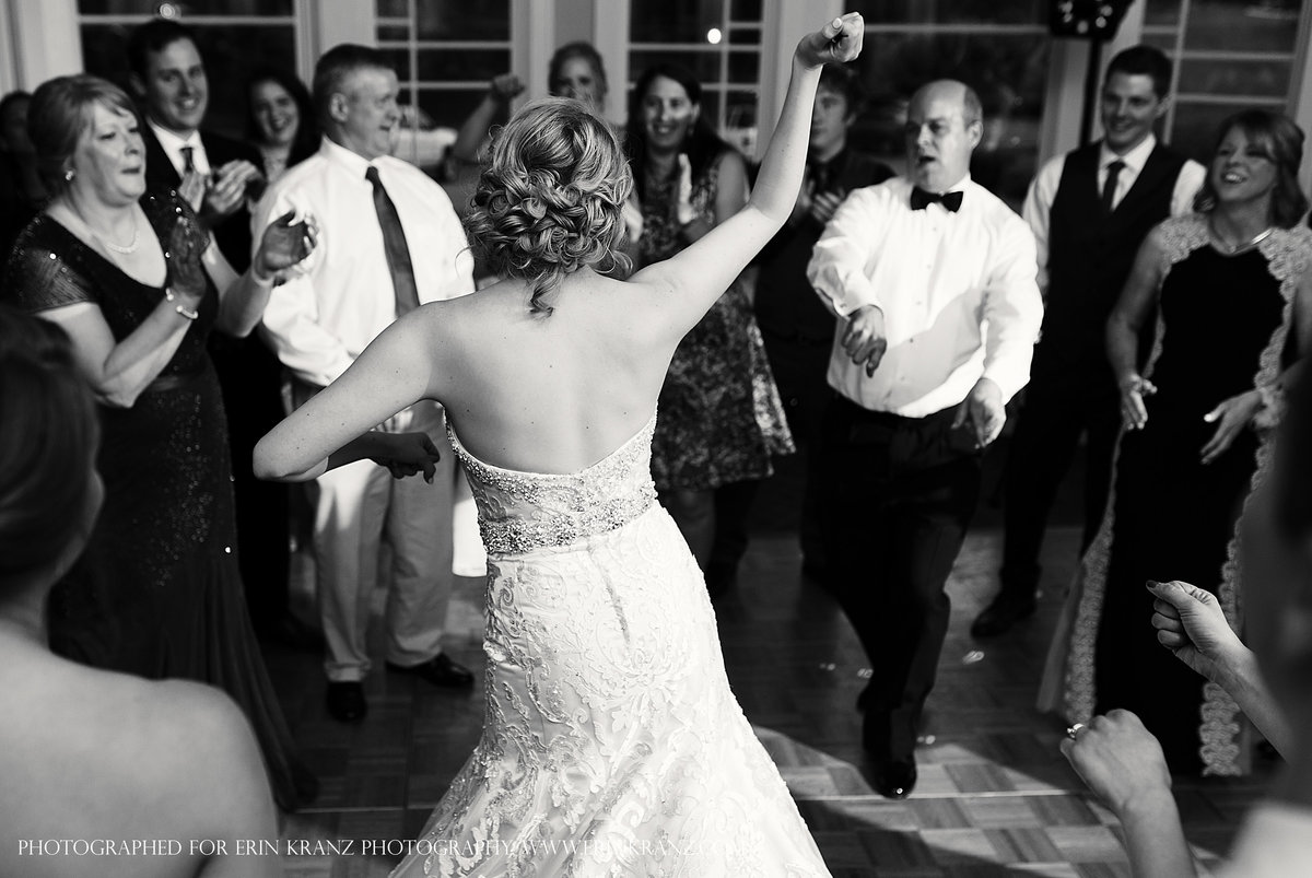 charlotte wedding photographer jamie lucido captures the documentary detail at a reception with the bride dancing with her father and the guests cheering on