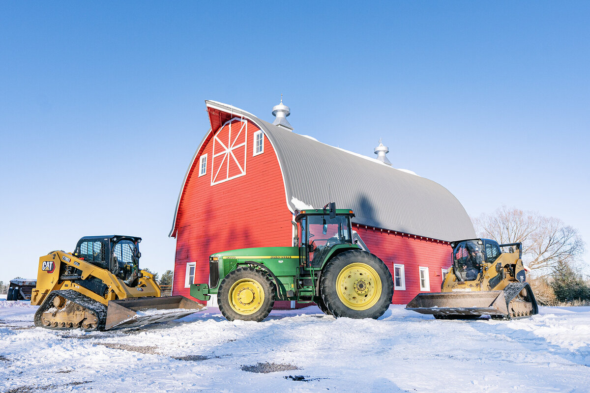 barn with tractor and skidsteer