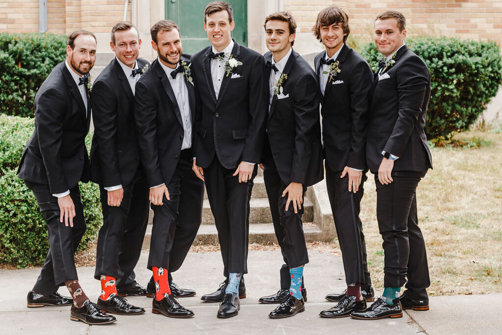Groomsmen showing off their socks
