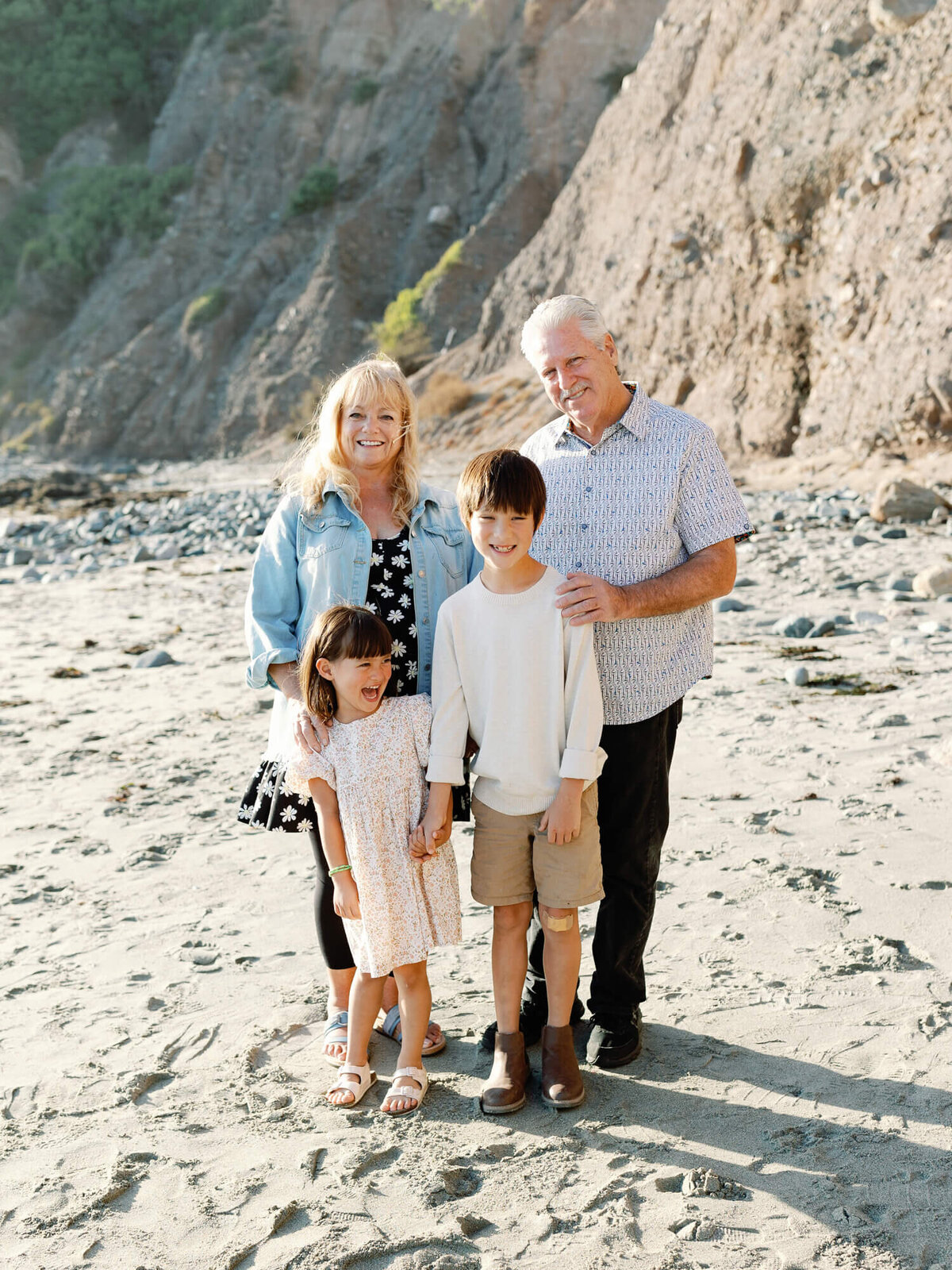 grandparents and kids at the beach posing for family photo