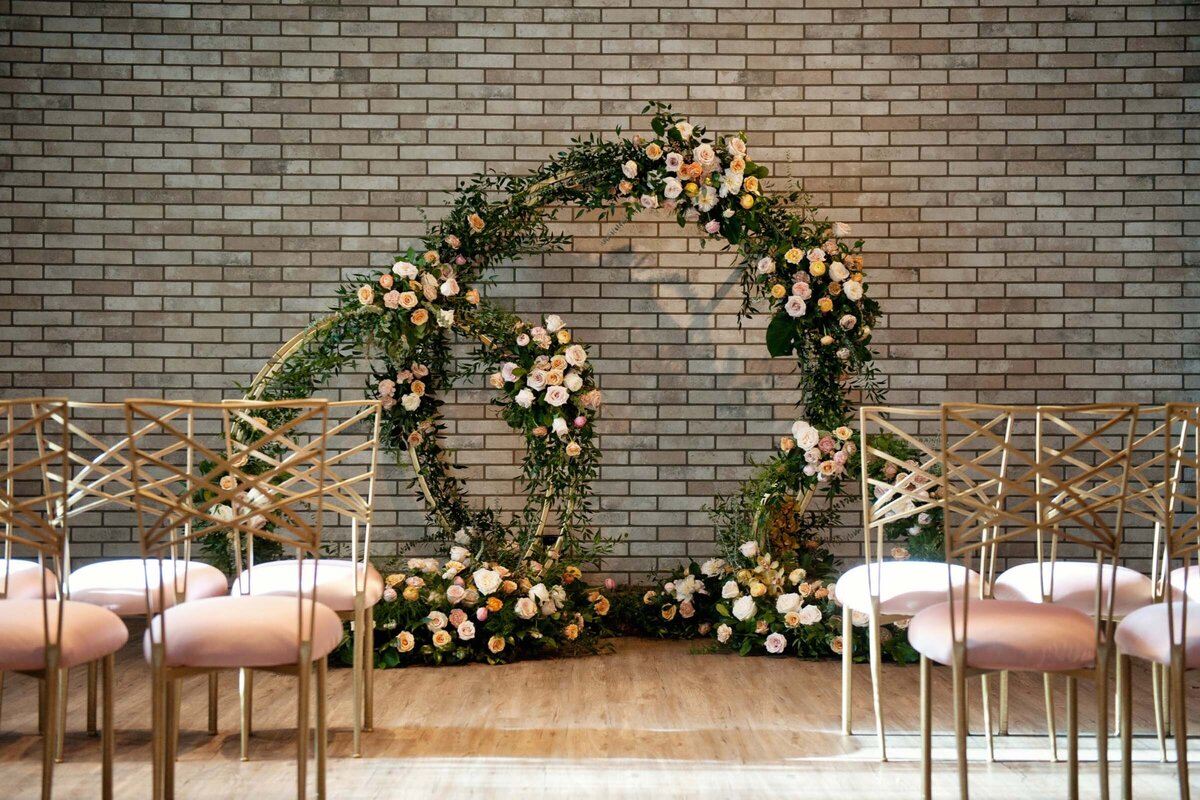 Gorgeous indoor ceremony at Hudson, a modern industrial wedding venue in Calgary, featured on the Brontë Bride Vendor Guide.