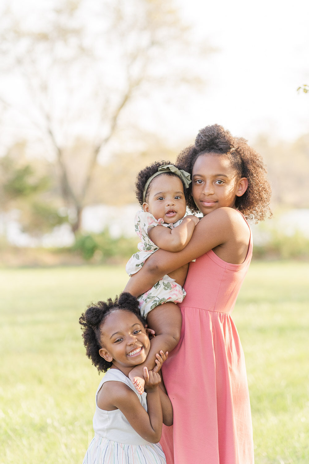 3 siblings posing for photos during spring minis in Reston, Virginia