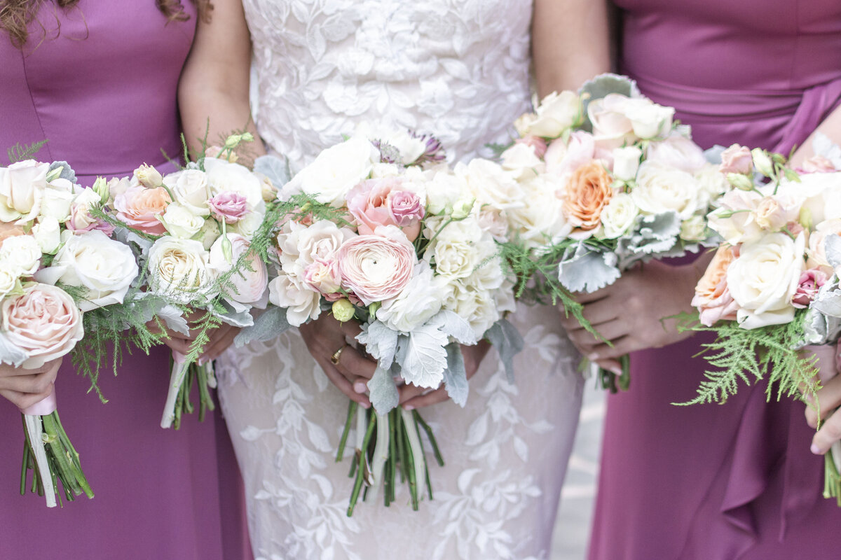 bridesmaids in purple holding wedding bouquets at House Mountain Inn