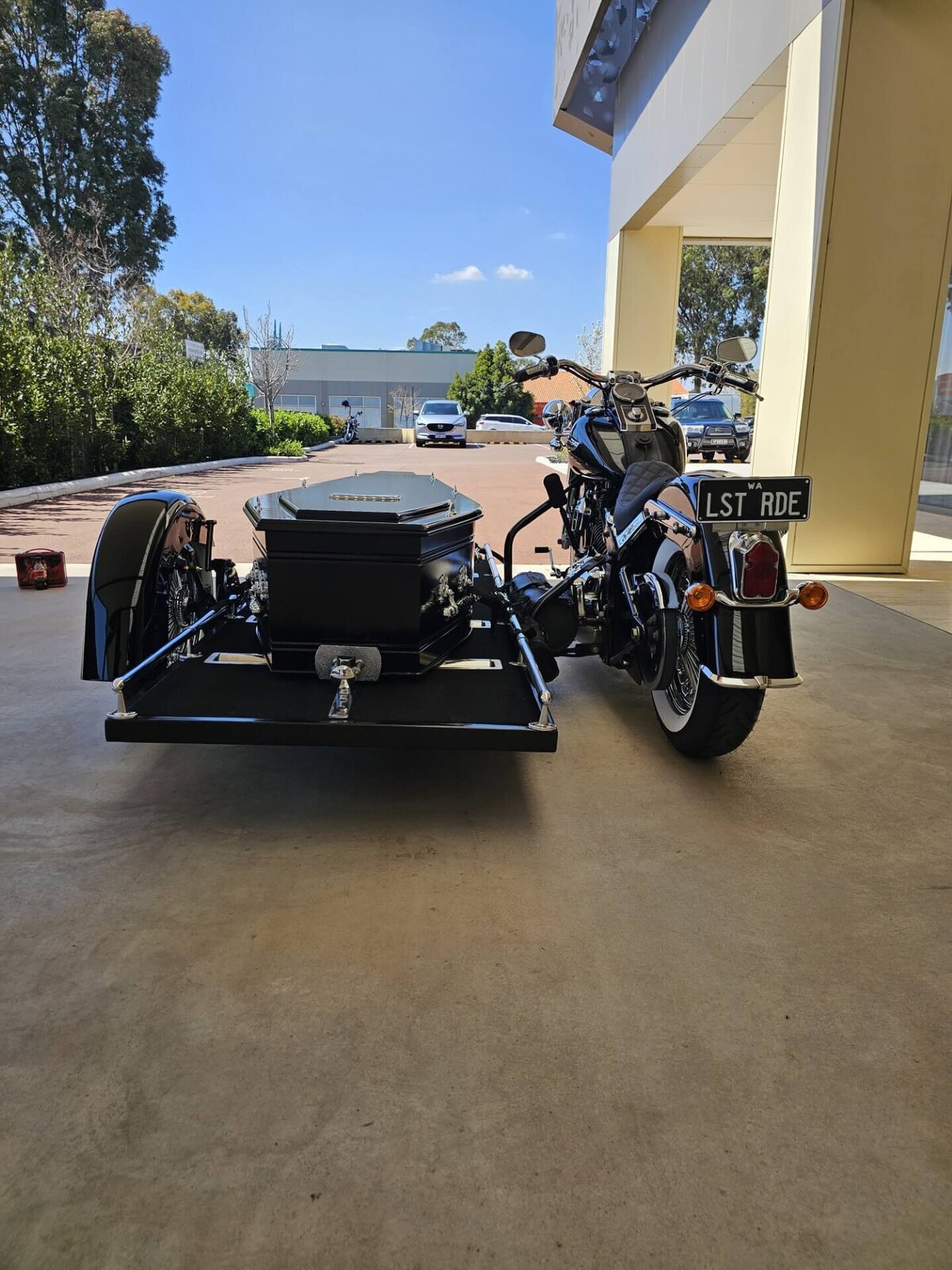 Rear angle of the Harley Davidson hearse, highlighting the casket carriage used for unique and respectful funeral services in WA.