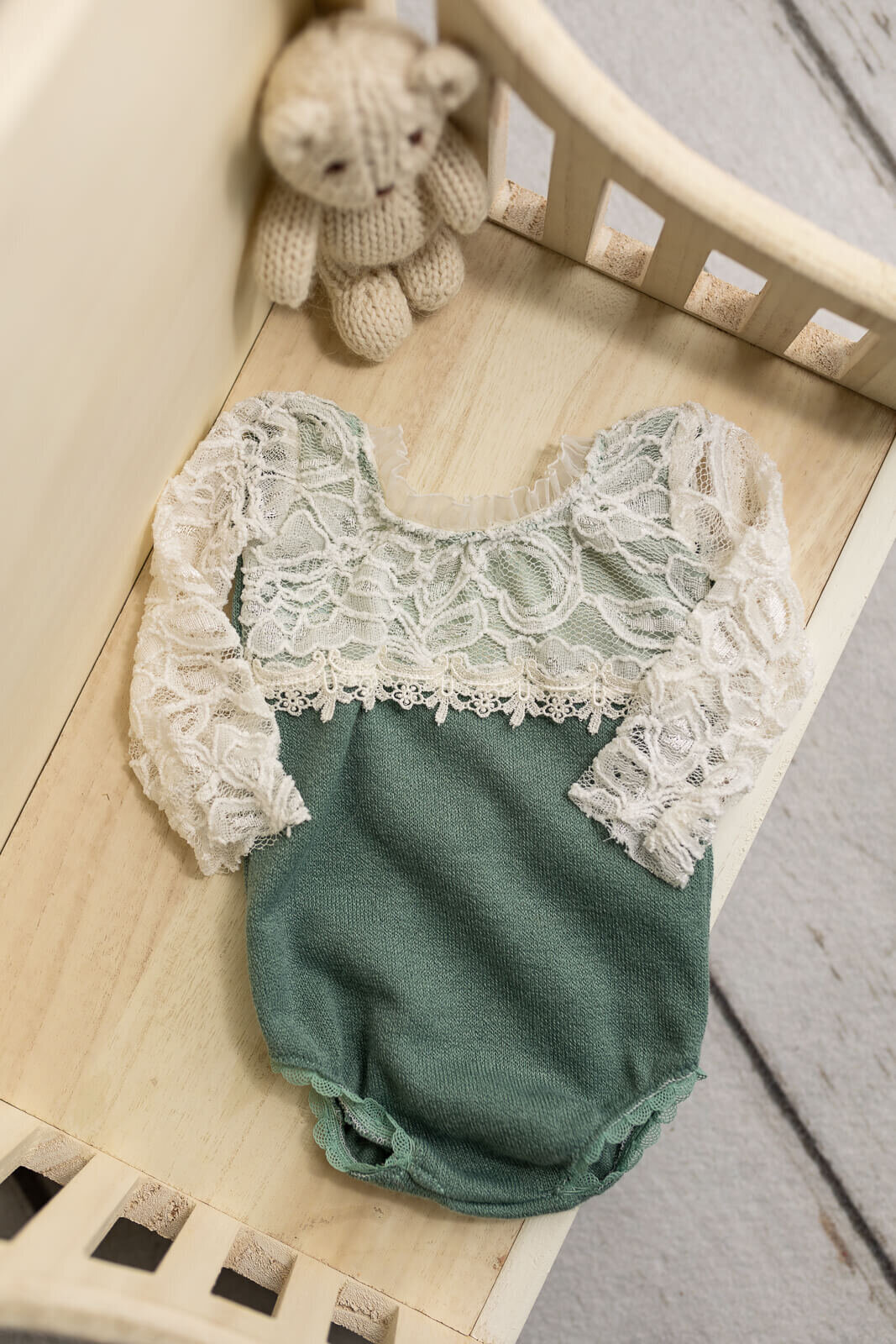 Elegant lace top sage romper used for newborn studio session in Southern Minnesota.