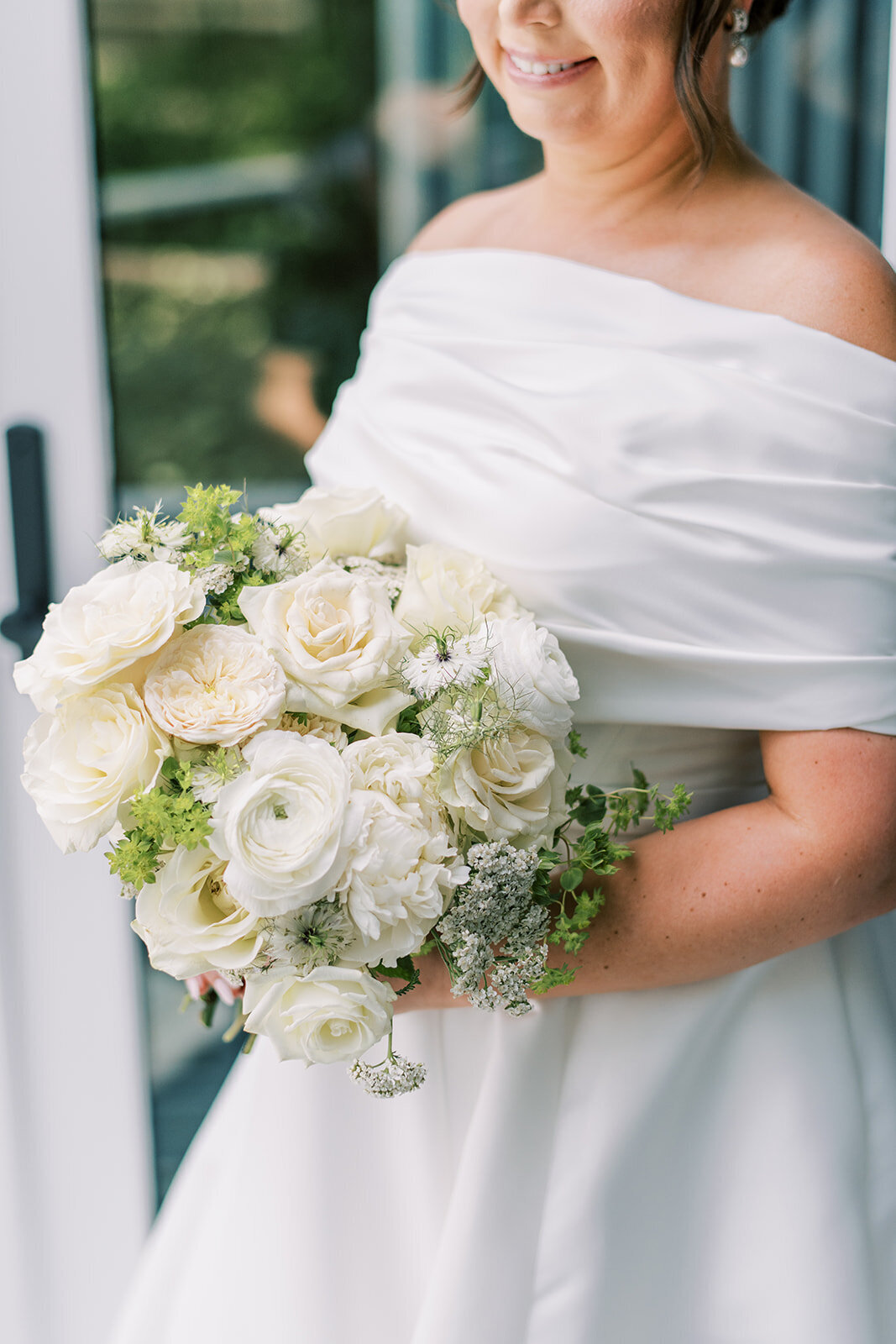  Bride holding white bouquet wearing an off-the-shoulder gown at Trillium Links & Lake Club wedding.