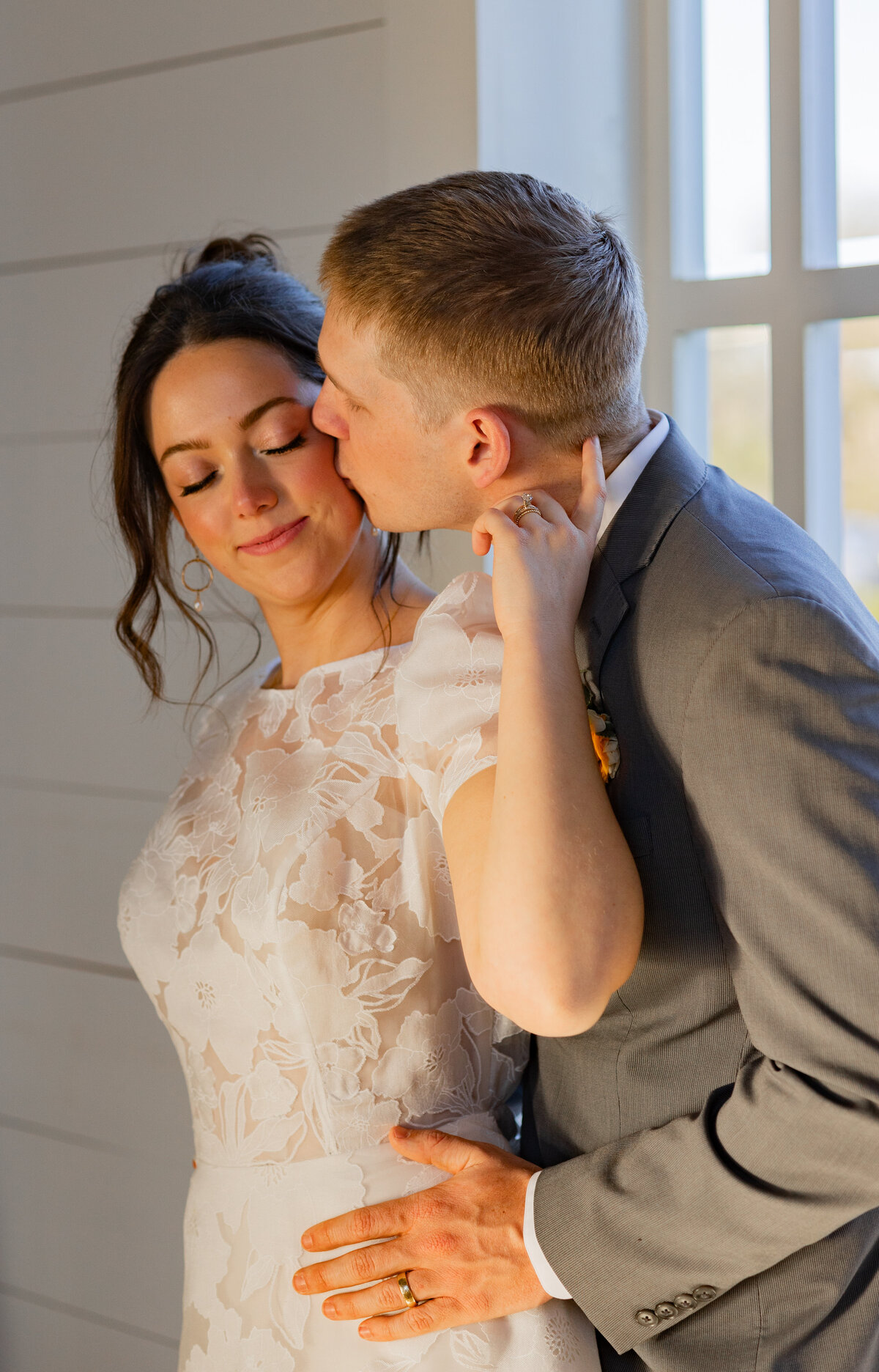 groom kissing brides cheek in Alexandria Virginia by Washington DC wedding photographer Amanda Richardson Photography