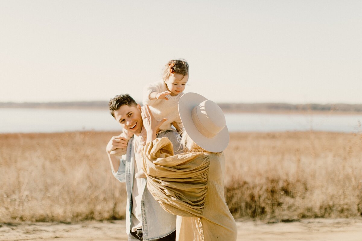 family beach photos with baby  on dad's shoulders