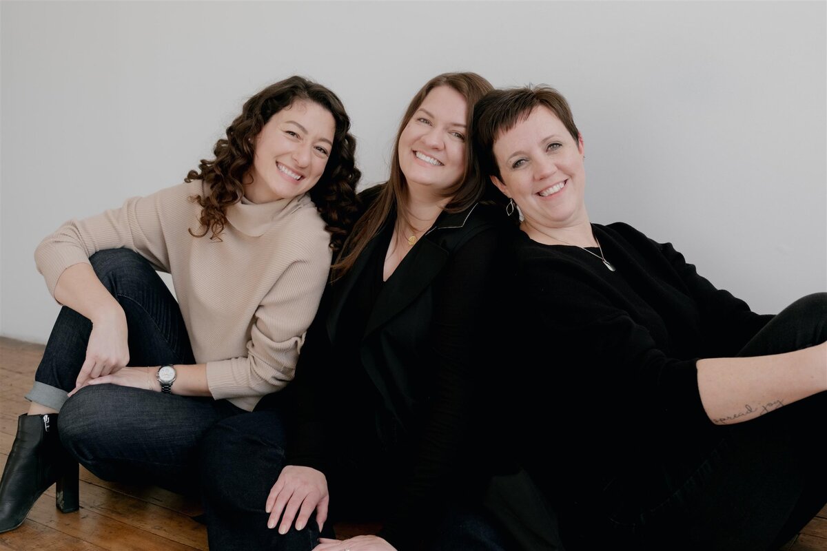Portrait of Hudson Valley wedding planning team, Canvas Weddings. Three women smiling in  a studio portrait.