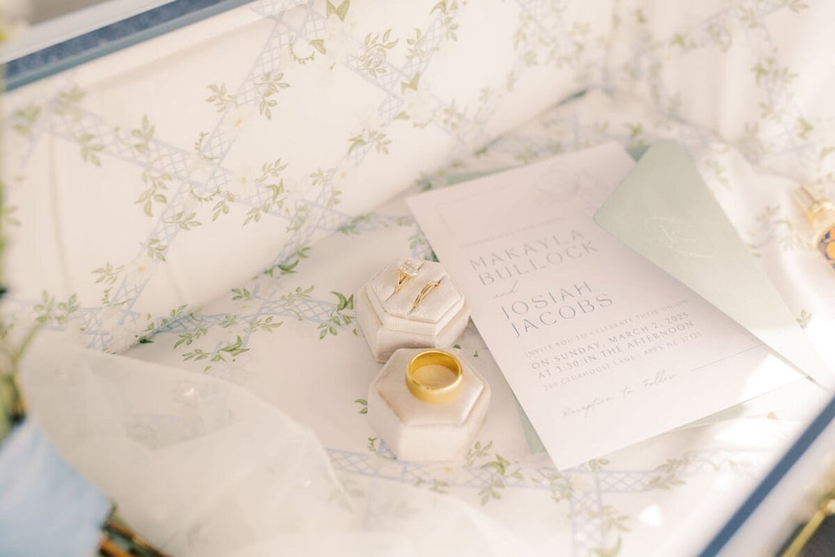 A bride and groom clink glasses in a romantic, candlelit setting, celebrating their new life together with smiles and joy at their beautifully decorated reception table.