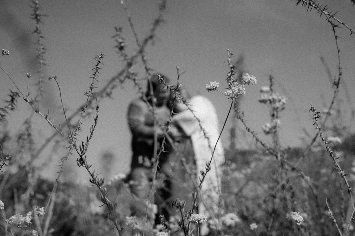 Abstract photo of family through a flower patch in the San Diego area.