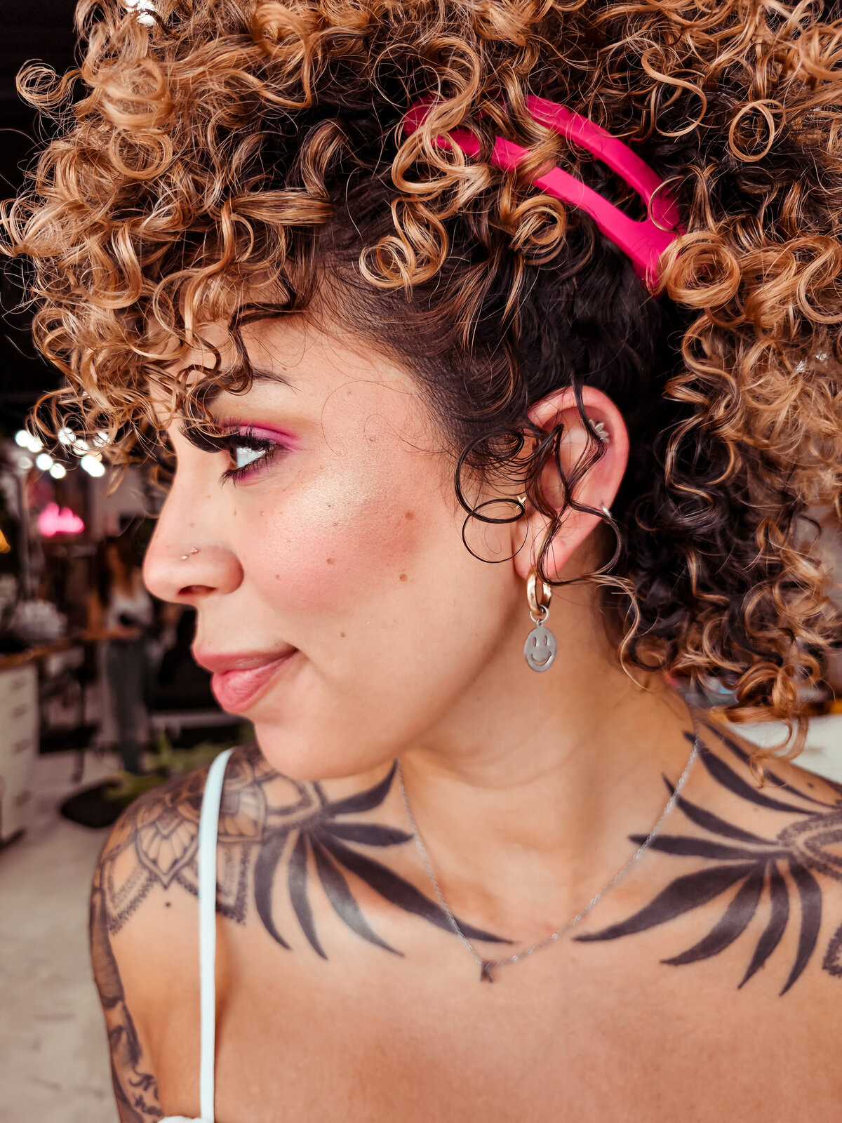 Gorgeous warm curly hair in an upstyle perfectly frames the tattoos on Moxie by KC's client