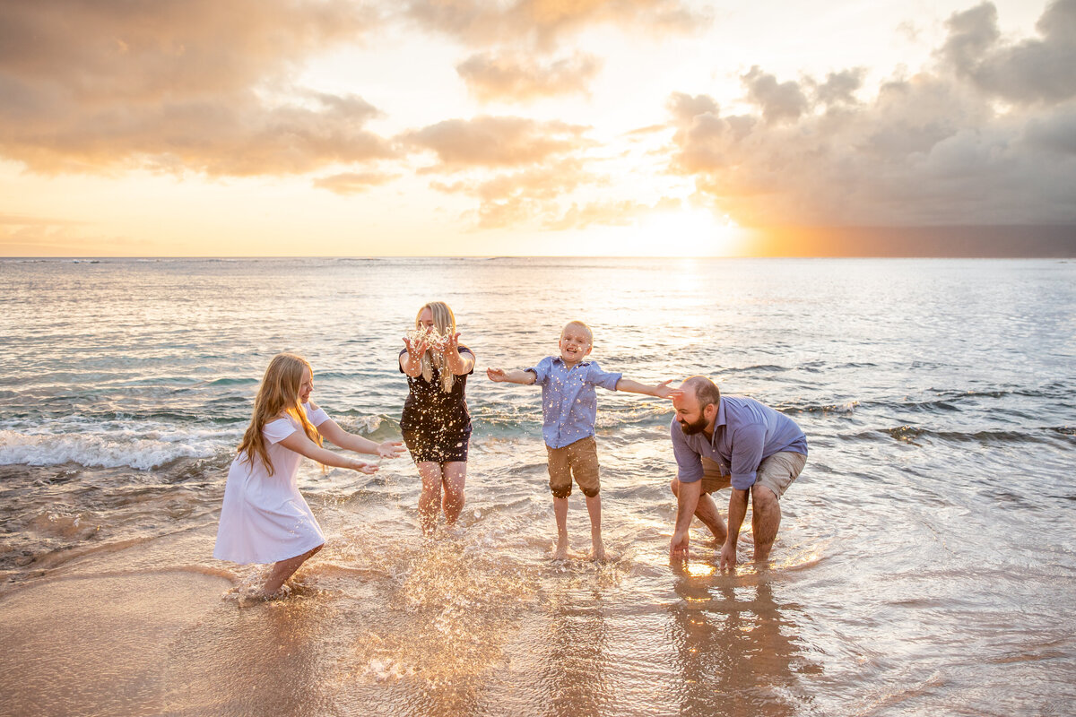 Maui Family Photographers capture family playing in water during beach family photos