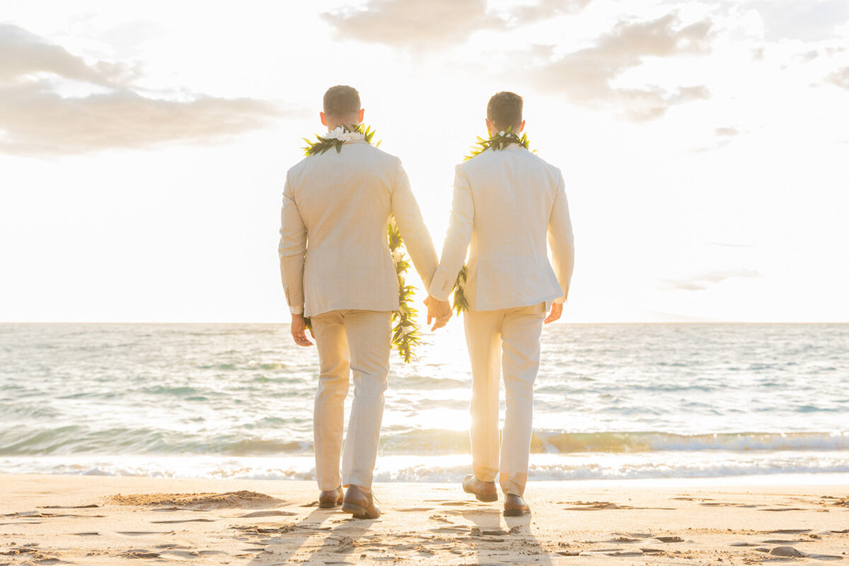wedding photography of two grooms walking on the beach in Maui, Hawaii