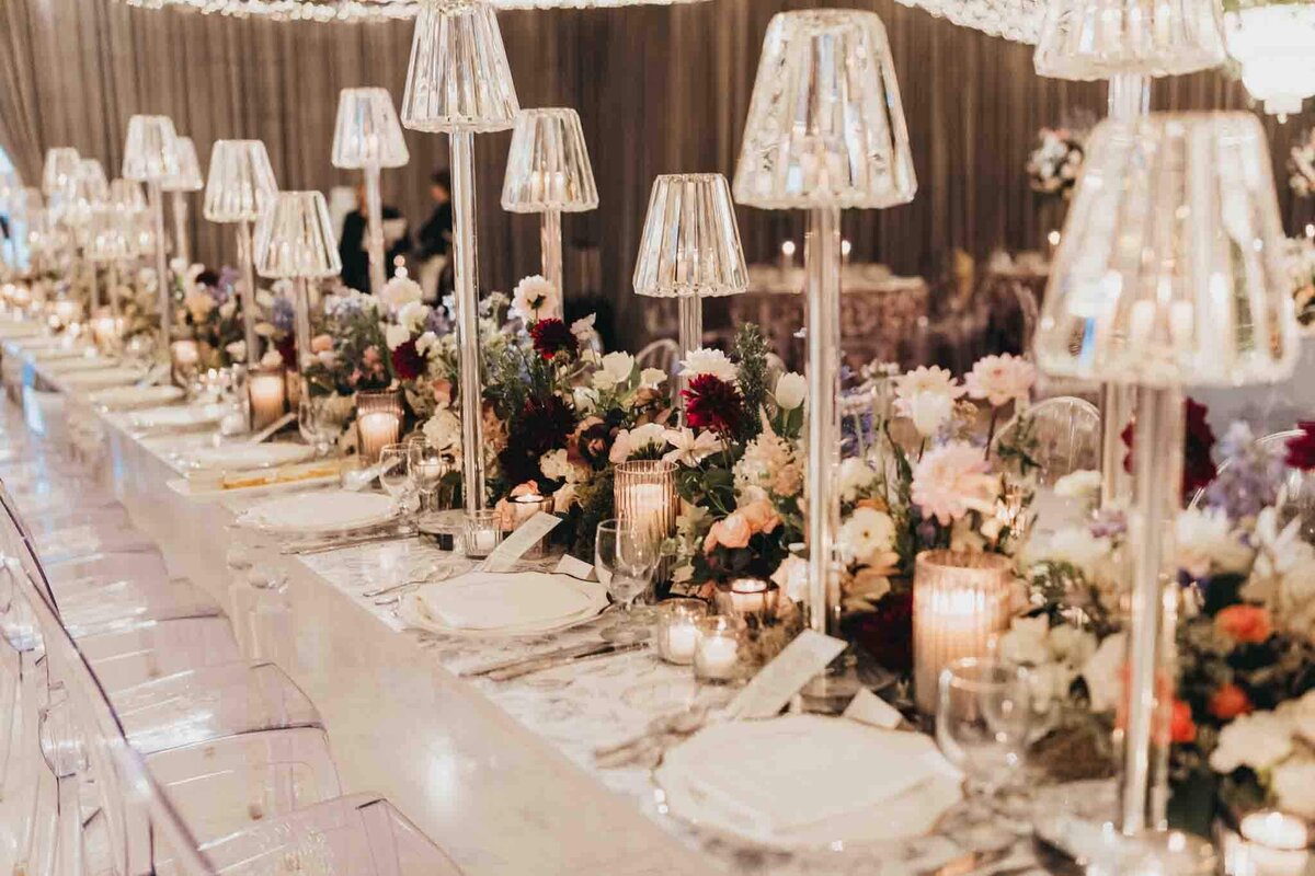 glass lamps and acrylic chairs make for a gorgeous setup for wedding decor.