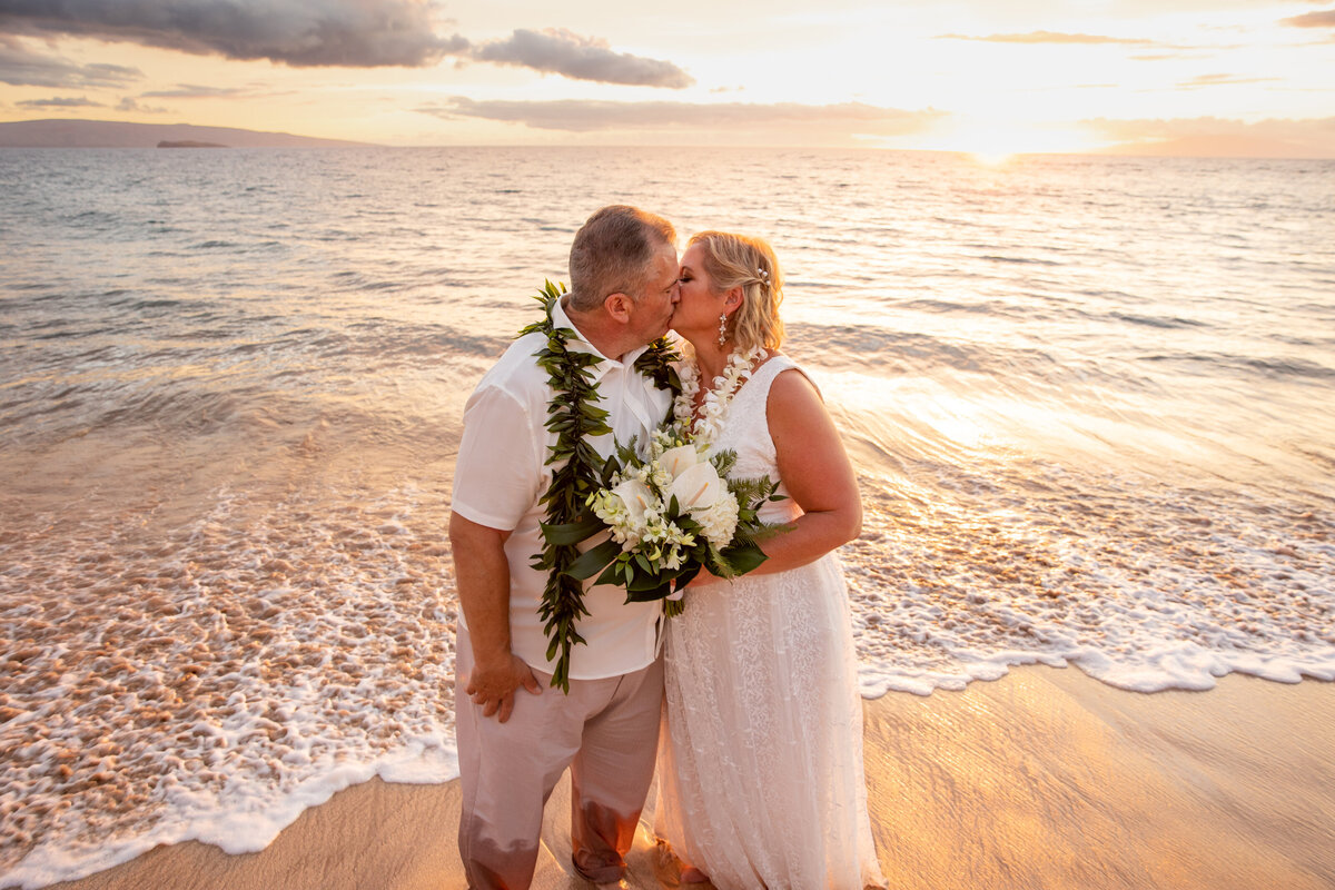 Maui Wedding Photographer captures bride and groom kissing at sunset