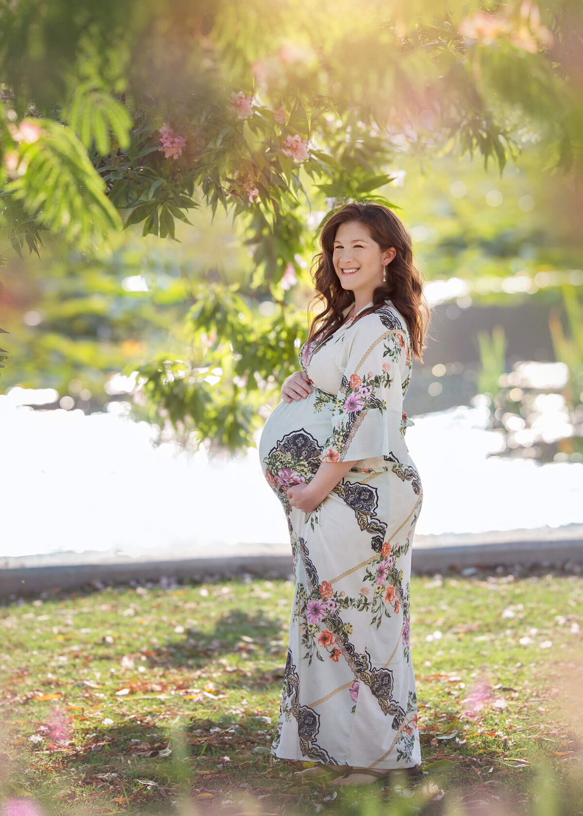 Mommy to be holding baby bump at Echo Lake Park in Los Angeles by Elsie Rose Photography