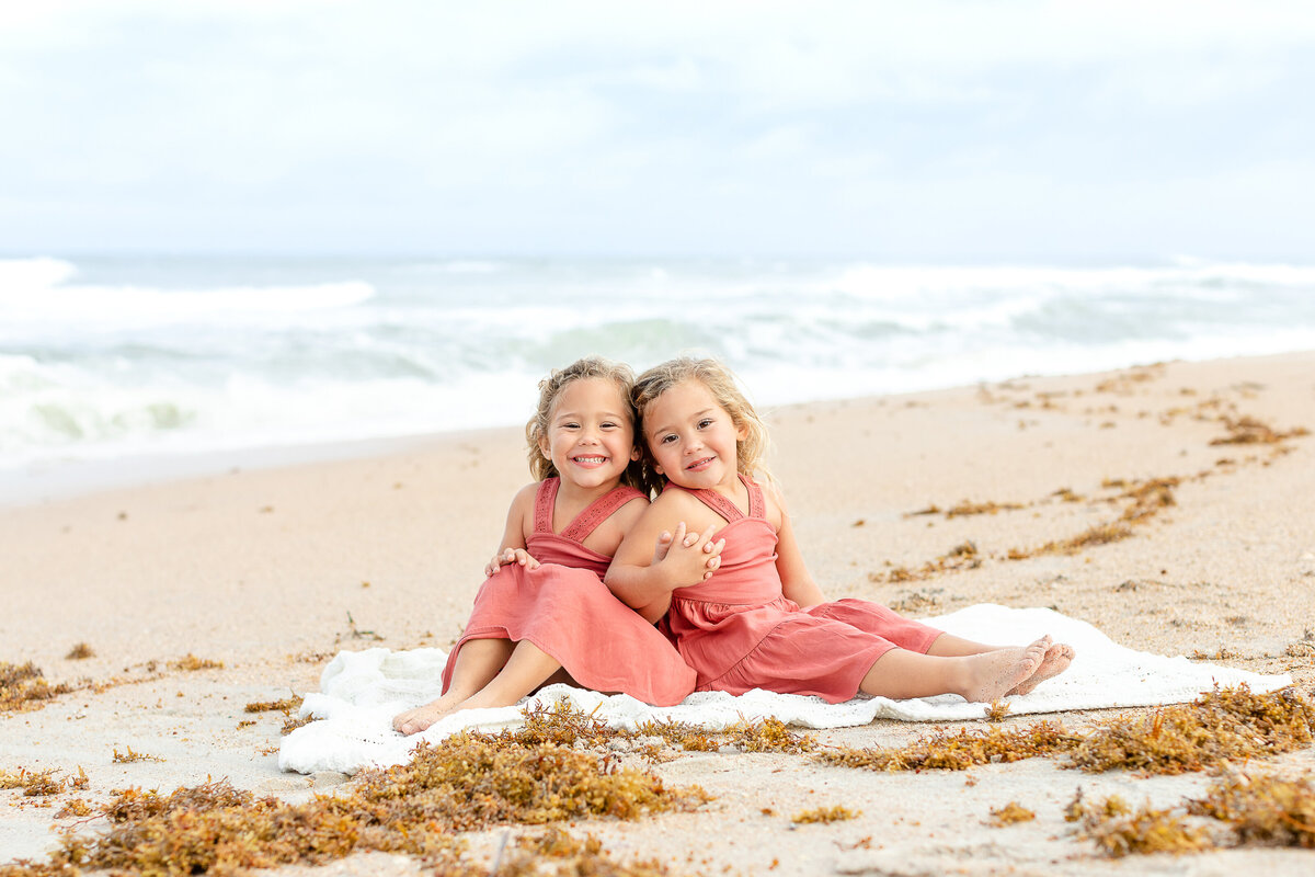 Twin girls pose on the beach in Ponte Vedra Beach