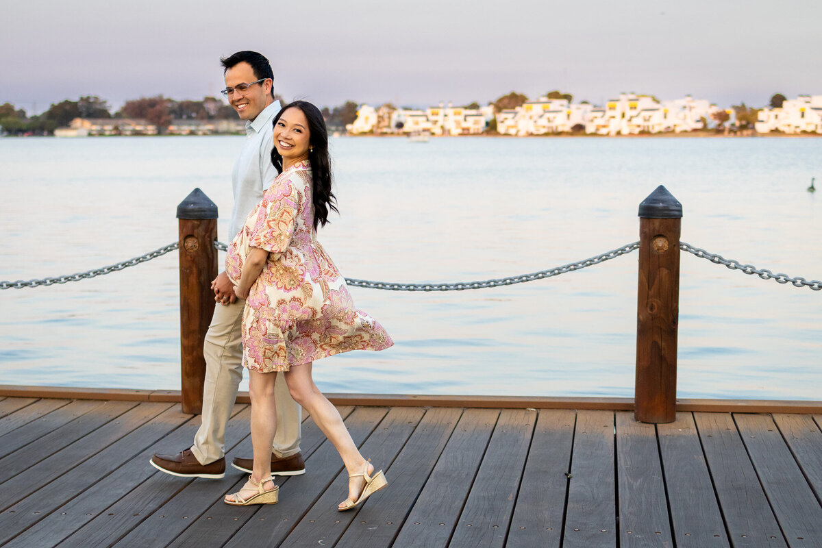 Joyful maternity walk on the dock with mom-to-be smiling at camera — Bay Area Maternity Portfolio - Ellobelle Photography