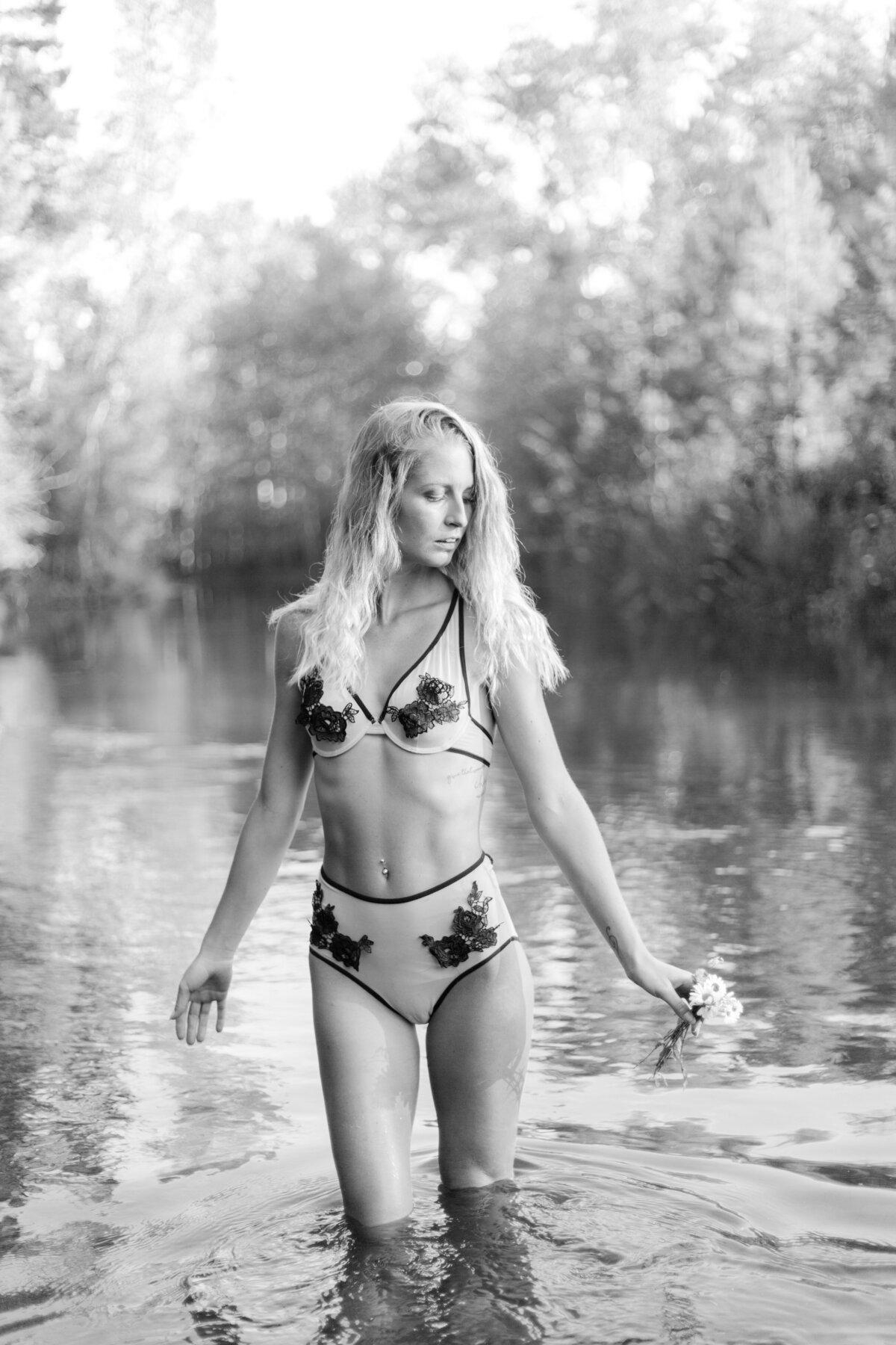 black and white image woman posing in river