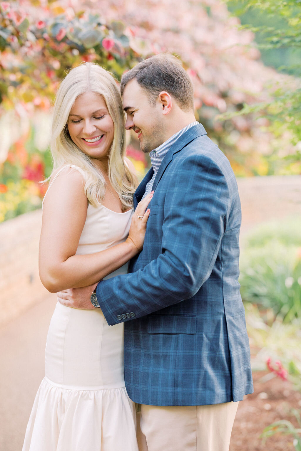 Woman smiles softly with finace in Athens Botanical gardens