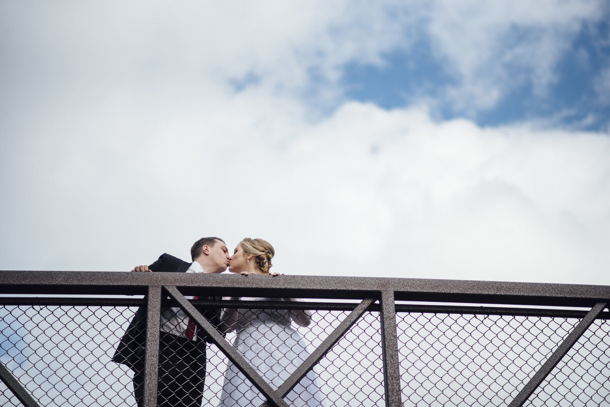 kissing on a bridge and clouds