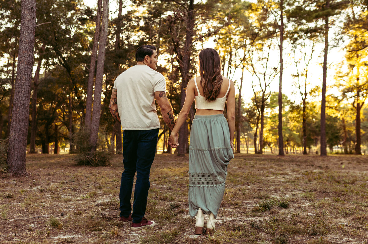married couple walks away holding hands at sunset in panama city fl