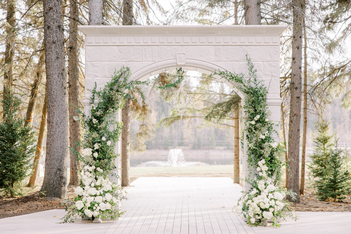 Stunning ceremony arch at Archway Manor Weddings & Events, elegant, timeless, European-inspired Red Deer, Alberta wedding venue, featured on the Brontë Bride Vendor Guide.