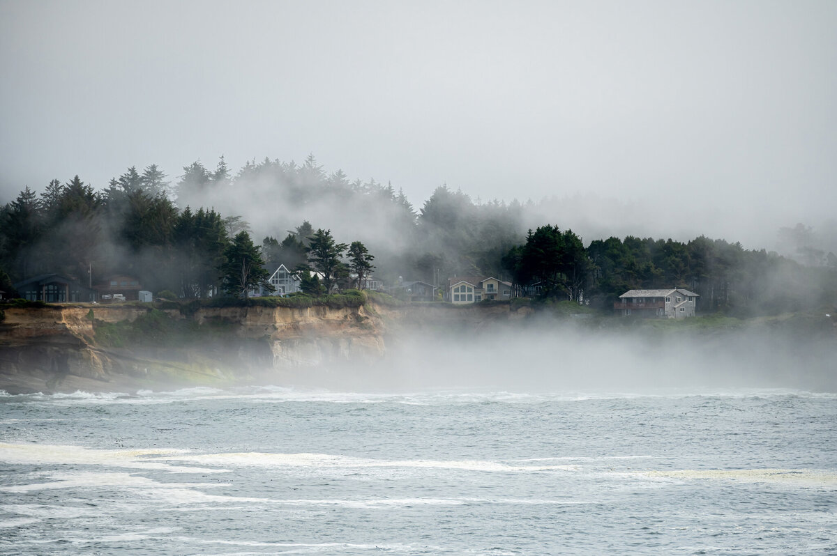 As fog rolls in the Oregon coas, you can hardley see the ocean front homes.
