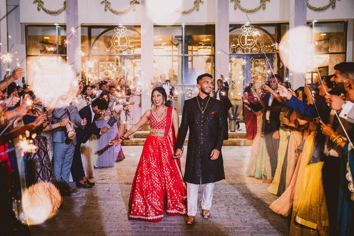 Indian Christian bride and groom walking through their sparkler exit after the wedding reception at Leonard's Palazzo