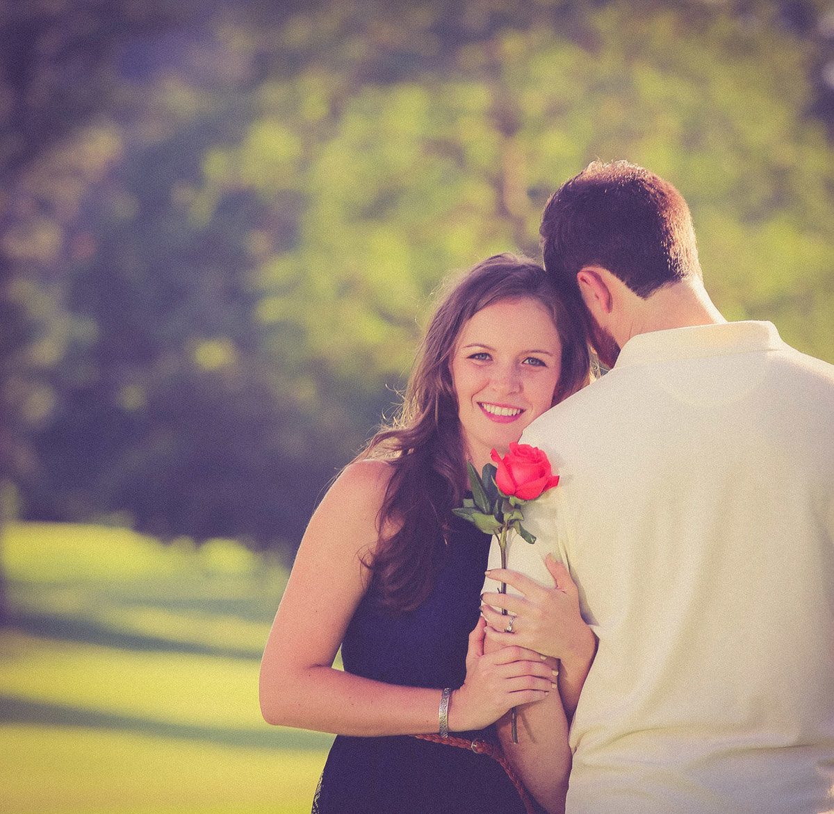Woman holding a red rose and the arm of her fiance. Photo by Ross Photography, Trinidad, W.I..