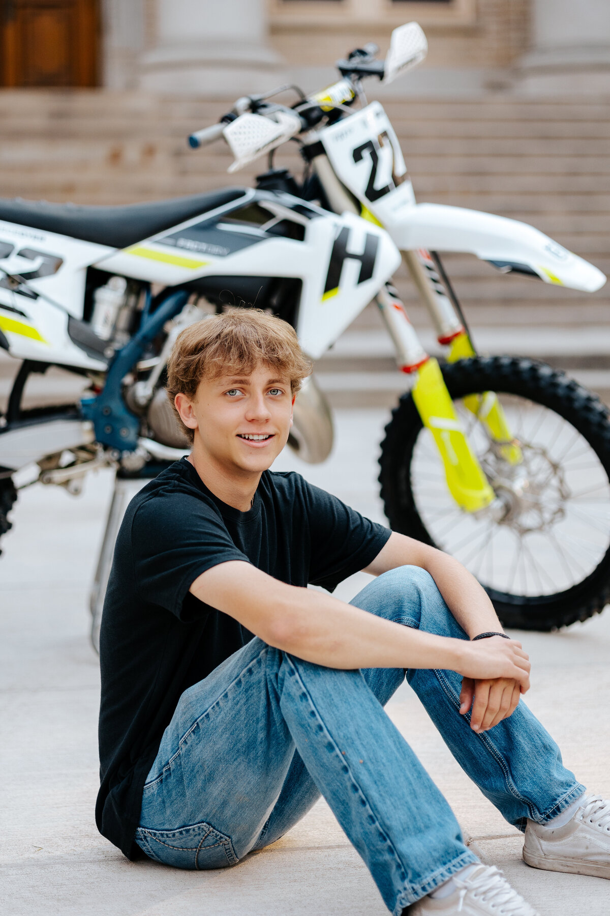 A high school senior poses for a photo in front of his motorcycle in Fort Collins, Colorado.