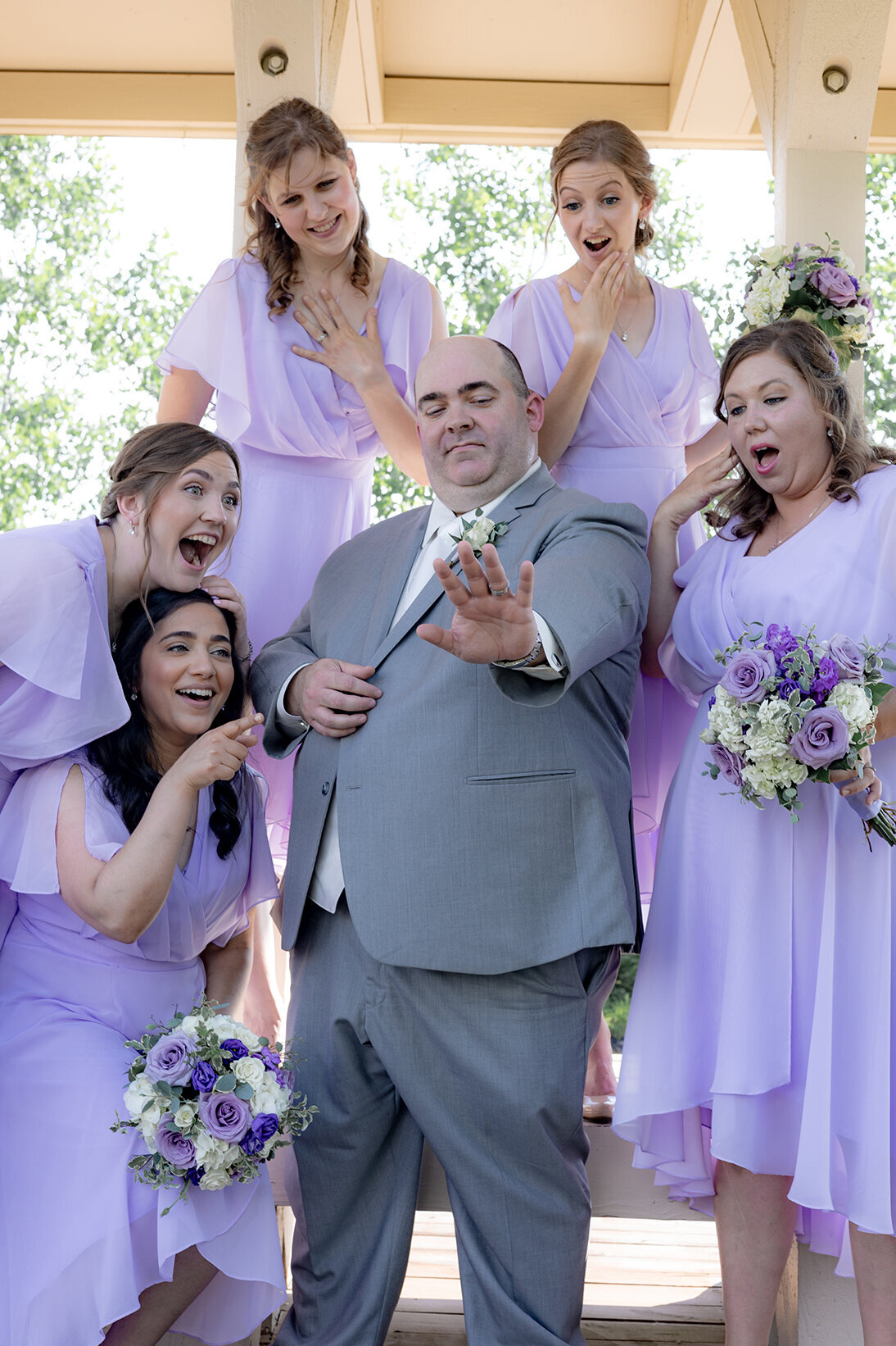 playful-groom-and-bridesmaid-photo-fun
