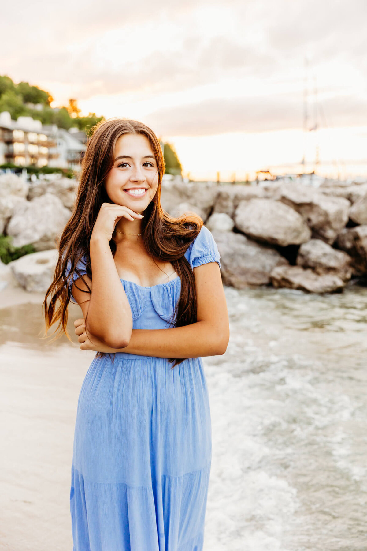 stunning high schooler in a light blue dress resting her chin on her hand captured by Ashley Kalbus Photography