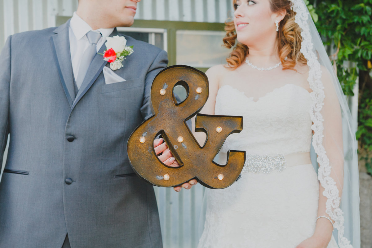 Creative photo of bride and groom holding wedding sign in Oregon