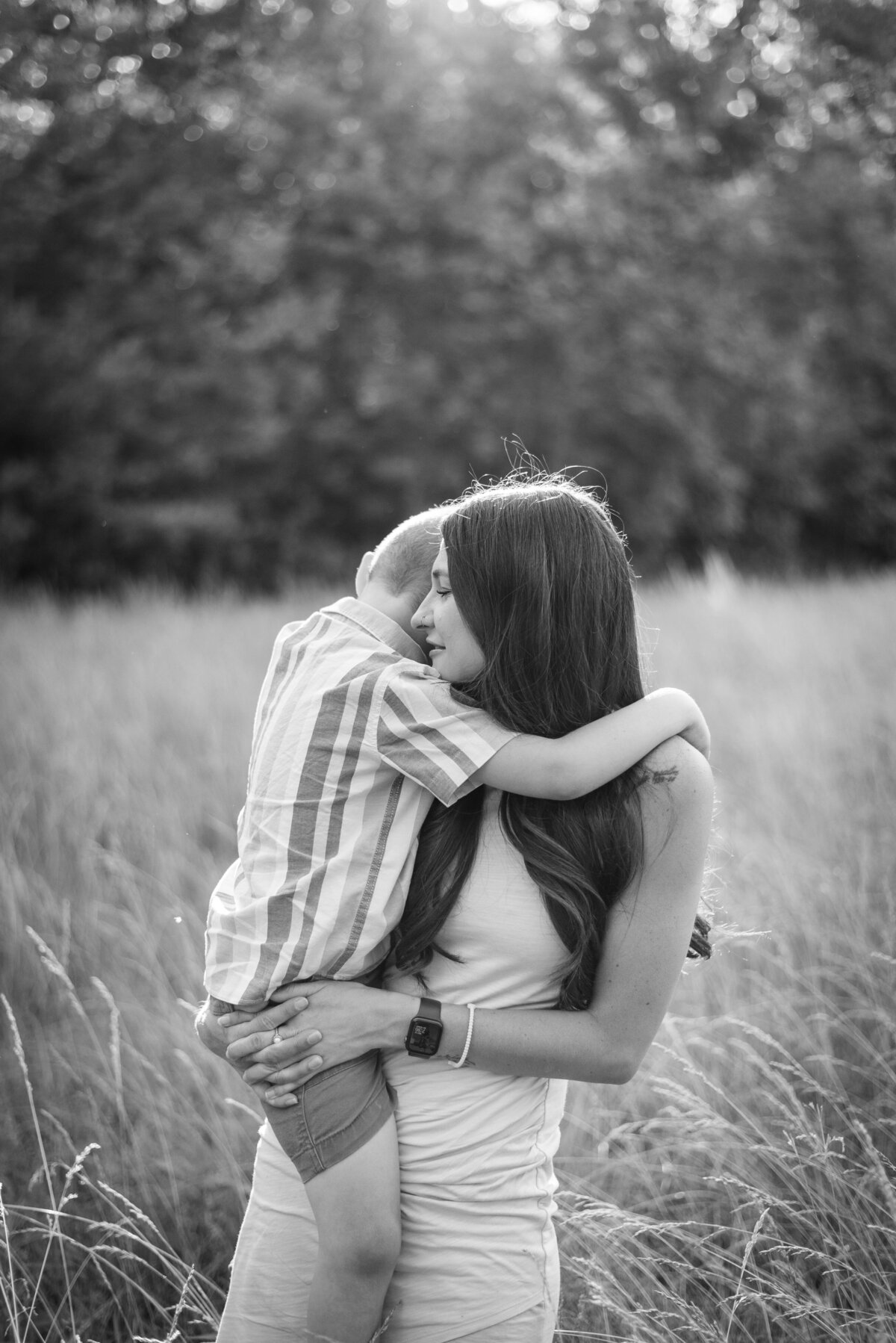mother son black and white photo hugging in field ouabache state park in bluffton family photographer northeast indiana