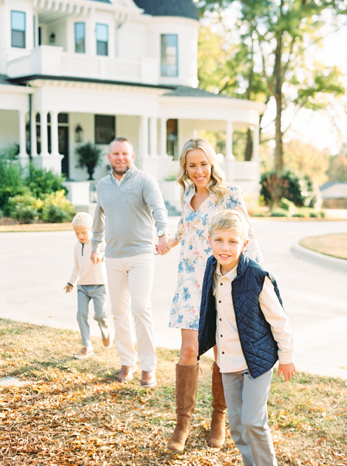 Family walks and laughs for a portrait at the Carolina Manor in Franklinton. Image by Raleigh maternity photographer A.J. Dunlap Photography.