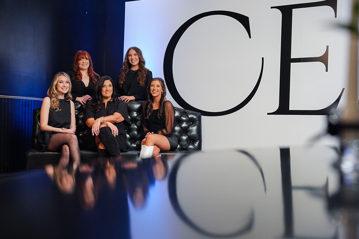 kansas-city-team-group-photography-0007-group-of-women-sitting-in-front-of-sign