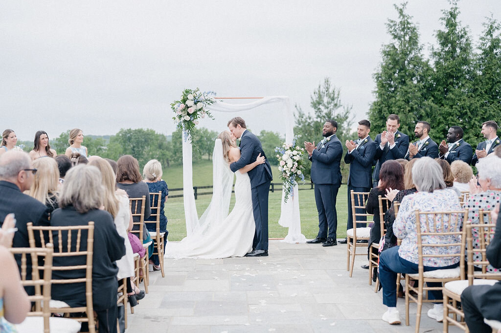 Wedding couples kiss in front of everyone