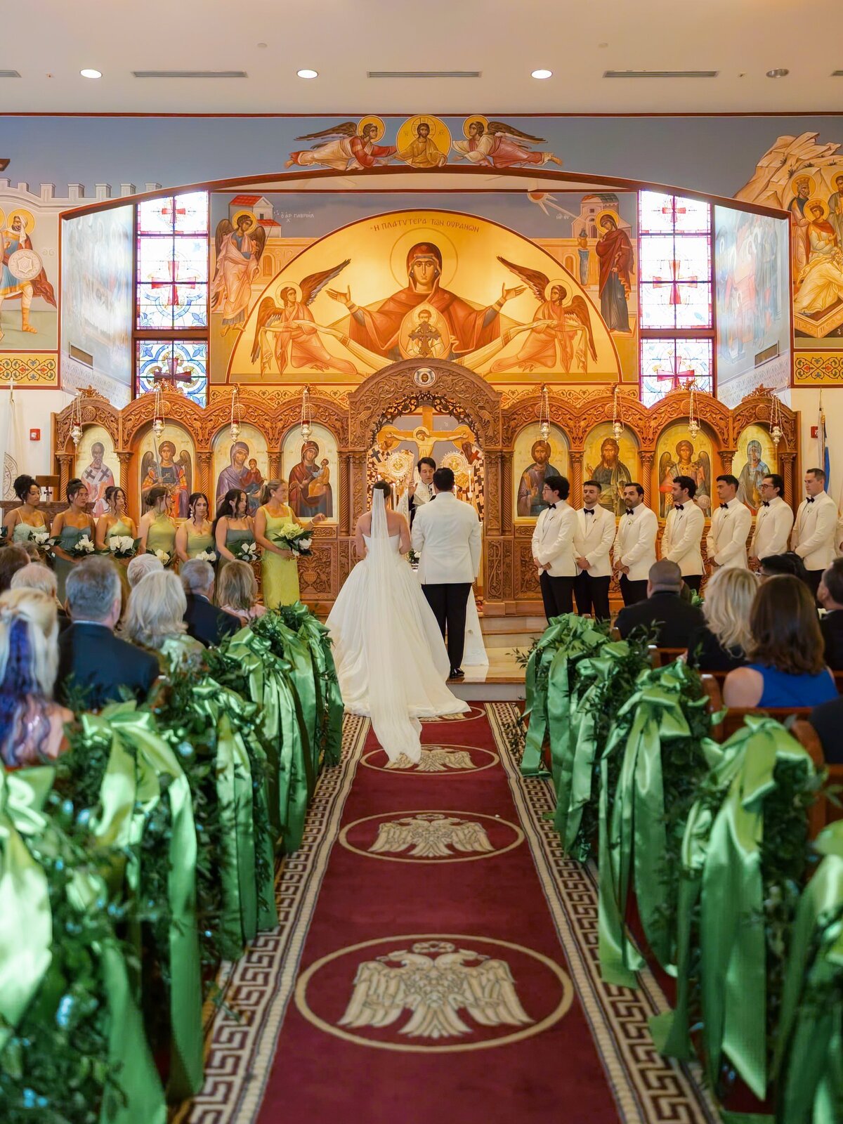 Kara and Nick at the altar of St. Anna’s Greek Orthodox Church, the aisle lined with green ribbon