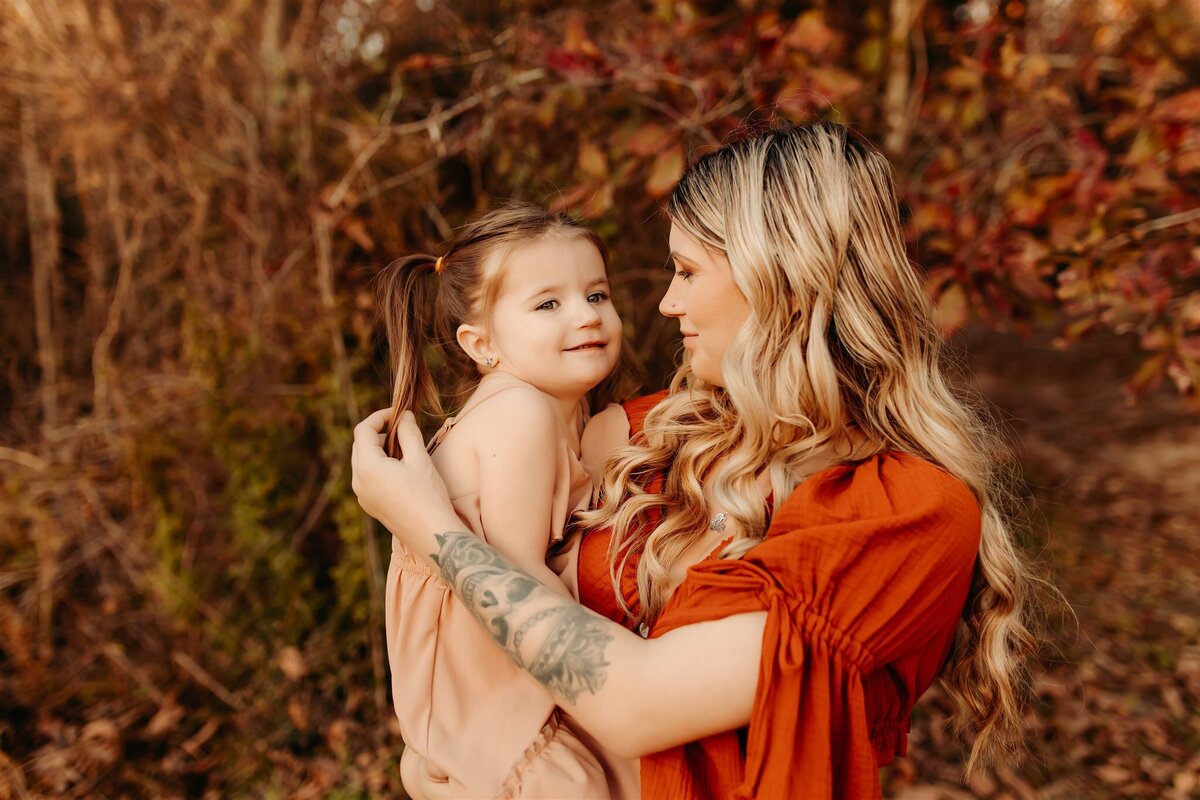 Baytown, Tx mother holding and playing with little girls hair photos